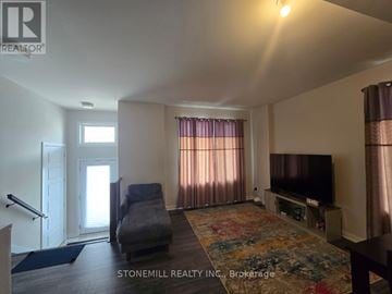 Ottawa townhouse for rent - A living room with a grey couch and a flat screen TV.