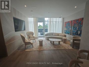 Toronto (Regent Park) condo for rent - A living room with a flat screen TV and a large painting on the wall.