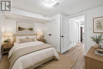 Toronto (O'connor-Parkview) townhouse for rent - A bedroom with a large bed and a painting on the wall.