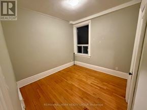 Ottawa triplex for rent - A room with a wooden floor and a window.