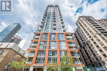 Toronto (Waterfront Communities) condo for rent - A kitchen with a black fridge, white countertops, and a microwave above the stove.