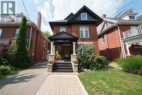 Brantford apartment for rent - A brick house with a black roof and a porch.