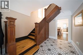 Brantford apartment for rent - A wooden staircase with a black and white patterned carpet.