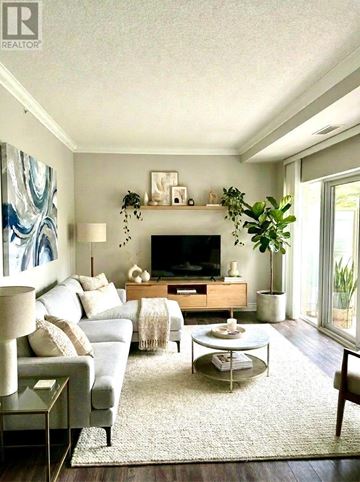 Toronto (Bayview Village) condo for rent - A living room with a blue couch and a glass coffee table.