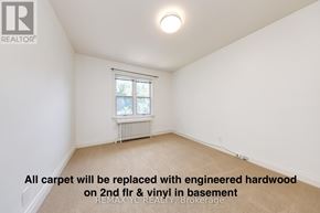 Toronto (Leaside) apartment for rent - A room with a window and a radiator, with a note on the floor.