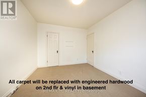 Toronto (Leaside) apartment for rent - A room with a carpet floor and a door on the left.