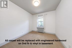 Toronto (Leaside) apartment for rent - A room with a window and a radiator, with a note on the floor.