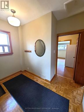Toronto (Runnymede-Bloor West Village) duplex for rent - A room with a mirror and a rug on the floor.