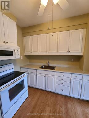 Toronto (Runnymede-Bloor West Village) duplex for rent - A kitchen with white cabinets and appliances.