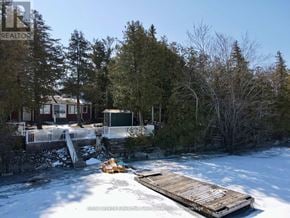 Ramara apartment for rent - A house with a deck in the snow.