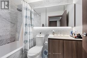 Toronto (Waterfront Communities) condo for rent - A modern bathroom with a toilet, sink, and shower.