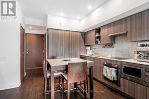 Toronto (Waterfront Communities) condo for rent - A kitchen with a table and chairs in the middle of it.