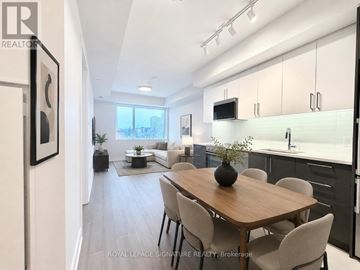 Toronto (University) condo for rent - A modern kitchen with a dining table and chairs.