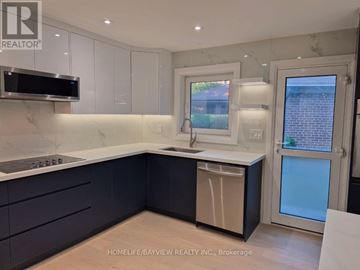 Markham (Royal Orchard) apartment for rent - A kitchen with a white counter top and dark cabinets.