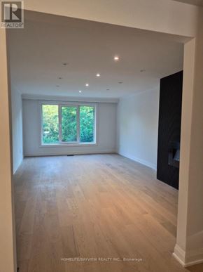 Markham (Royal Orchard) apartment for rent - A spacious room with wooden flooring and a large window.