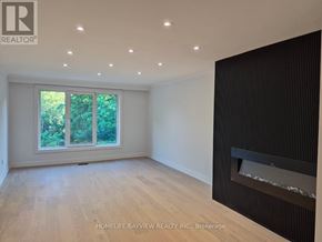 Markham (Royal Orchard) apartment for rent - A room with a fireplace and a window overlooking trees.
