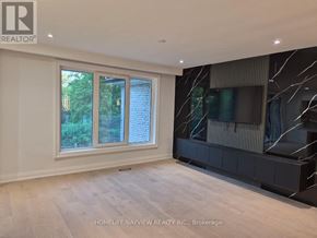Markham (Royal Orchard) apartment for rent - A room with a large window and a flat screen TV mounted on the wall.