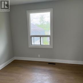 Halton Hills (Rural Halton Hills) apartment for rent - A room with a window and wooden flooring.