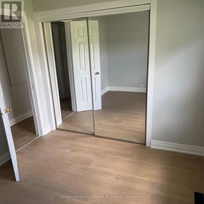 Halton Hills (Rural Halton Hills) apartment for rent - A room with a white door and a mirror on the wall.