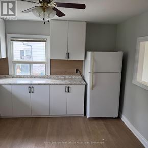 Halton Hills (Rural Halton Hills) apartment for rent - A kitchen with white cabinets and a white refrigerator.