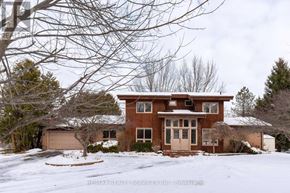 Caledon (Caledon East) apartment for rent - A house with a brown exterior is surrounded by snow.