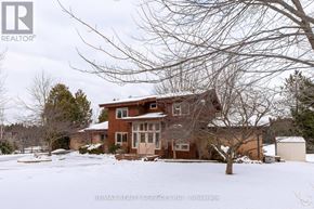 Caledon (Caledon East) apartment for rent - A house with a snow-covered front yard.