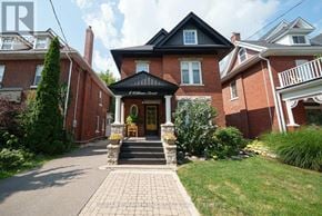Brantford apartment for rent - A brick house with a black roof and a porch.