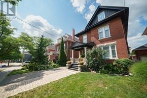 Brantford apartment for rent - A red brick house with a black roof and a white window.
