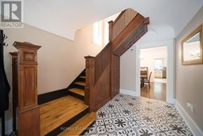 Brantford apartment for rent - A wooden staircase with a black and white patterned carpet.