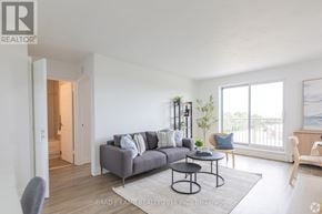 Hamilton (Rosedale) condo for rent - A living room with a grey couch, a small table, and a chair.