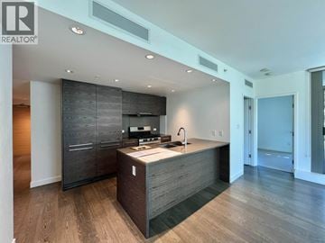 Vancouver apartment for rent - A modern kitchen with dark wood floors and cabinets.