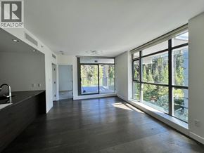 Vancouver apartment for rent - A spacious room with a large window overlooking a garden.