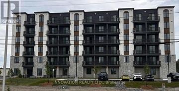 North Grenville apartment for rent - A multi-story building with balconies and a sign that reads "Innovation Realty LTD, Brokerage".
