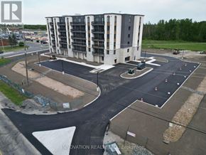 North Grenville apartment for rent - A large building with a parking lot in front of it.