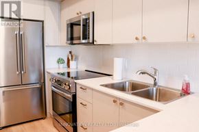 North Grenville apartment for rent - A modern kitchen with stainless steel appliances and white cabinets.