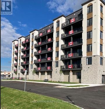 North Grenville apartment for rent - A building with balconies has Canadian flags on them.