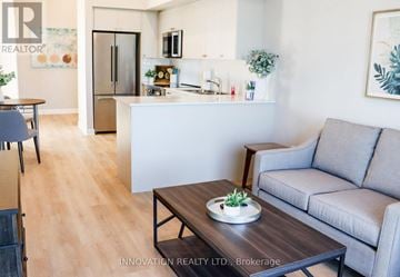 North Grenville apartment for rent - A modern living room with a grey couch and a wooden coffee table.