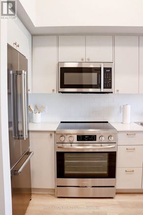 North Grenville apartment for rent - A modern kitchen with stainless steel appliances and white cabinets.