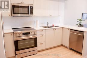 North Grenville apartment for rent - A modern kitchen with white cabinets and stainless steel appliances.