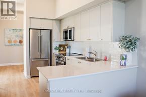 North Grenville apartment for rent - A kitchen with a refrigerator, oven, microwave, and sink.