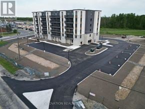 North Grenville apartment for rent - A large building with a parking lot in front of it.