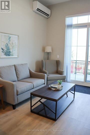 North Grenville apartment for rent - A living room with a grey couch, a coffee table, and a painting on the wall.