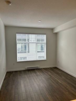 Surrey townhouse for rent - A room with a window and wooden flooring.