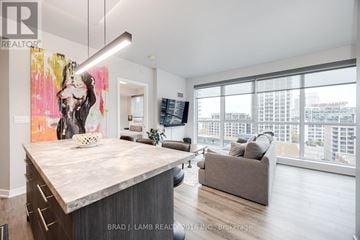 Toronto (Waterfront Communities) condo for rent - A modern living room with a large painting on the wall.