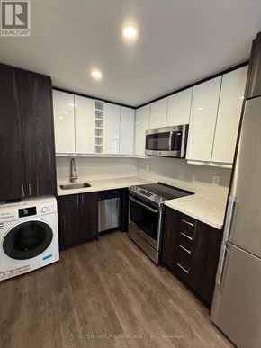 Toronto (Forest Hill South) house for rent - A modern kitchen with a washer and dryer built in.