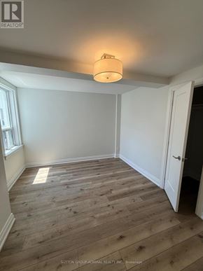 Toronto (Forest Hill South) house for rent - A room with wooden flooring and a light on the ceiling.