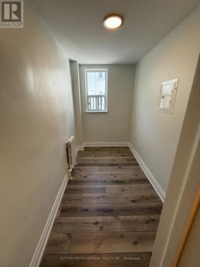 Toronto (Forest Hill South) house for rent - A hallway with wood flooring and white walls.