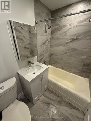 Toronto (Forest Hill South) house for rent - A bathroom with a marble tile wall and a white sink.
