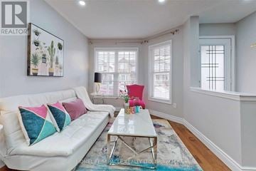 Brampton (Fletcher's Meadow) apartment for rent - A living room with a white couch and a glass coffee table.