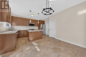 Brampton (Credit Valley) apartment for rent - A kitchen with brown cabinets and a white countertop.